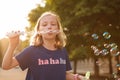 Young girl blowing bubbles outdoors Royalty Free Stock Photo