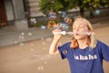 Young girl blowing bubbles outdoors Royalty Free Stock Photo