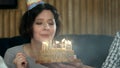 Young girl blowing candles on birthday cake