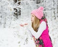Young girl blowing magic snow