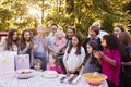 Young girl blowing out candles at her birthday garden party Royalty Free Stock Photo