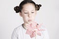 Young girl is blowing a stripy pin wheel Royalty Free Stock Photo