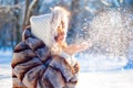 Young girl blows snow from her palms Royalty Free Stock Photo