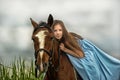 Young girl in a blue dress on a horse Royalty Free Stock Photo