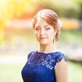 Young girl in blue lace dress looking straight Royalty Free Stock Photo