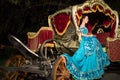 The young girl in blue old-fashioned dress sits in Royalty Free Stock Photo