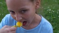 Young girl in blue t-shirt eat frozen juce icecream. Top-down shot closeup