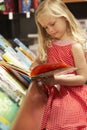 Young girl in bookshop Royalty Free Stock Photo