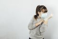 Young girl bored by quarantine prepares to leave home. White background. new normal concept. Royalty Free Stock Photo