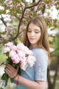 Young girl with a bouquet of peonies in the park, garden. Summer, spring Royalty Free Stock Photo