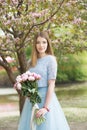 Young girl with a bouquet of peonies in the park, garden. Summer, spring Royalty Free Stock Photo