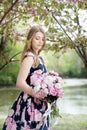 Young girl with a bouquet of peonies in the park, garden. Summer, spring Royalty Free Stock Photo