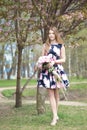 Young girl with a bouquet of peonies in the park, garden. Summer, spring Royalty Free Stock Photo