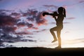 Young girl boxing at sunset.