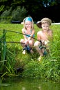 Young girl and boy fishing Royalty Free Stock Photo