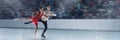 Young girl and boy performing on championship, professional figure skaters on 3D arena, ice rink. Beautiful stage