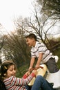 Young Girl and Boy Playing on Seesaw