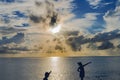 Young Girl Boy Pointing Sunset Cloudscape Water Moorea Tahiti Royalty Free Stock Photo