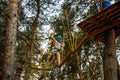 A young girl bravely overcomes an obstacle course on a playground in an adventure park