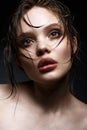 A young girl with bright creative makeup and perfect skin. Beautiful model with wet hair on face Royalty Free Stock Photo