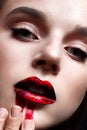 Young girl with bright evening makeup. Beautiful model with red lips and smeared lipstick. Pure shining skin. Beauty of the face Royalty Free Stock Photo