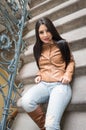 Young girl in brown leather boots and jacket