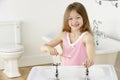 Young Girl Brushing Teeth at Sink Royalty Free Stock Photo