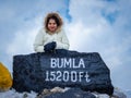 Young girl  at bumla pass india china border milestone board Royalty Free Stock Photo