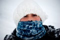 Young girl bundled up outside in snow.