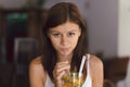 Young girl in cafe drinking cold lemonade Royalty Free Stock Photo