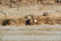 Young girl from Cambodian slums in the muddy water of Tonle Sap lake-Siem Reap, Cambodia 02/21/2011 .