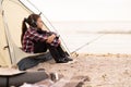 Young girl on camping trip.Child in a tent on beach listening music. Camping. Happy kid at summer vacations. travel Royalty Free Stock Photo