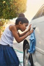 Young, girl and car in cleaning with cloth in outdoor for carwash at home for chores or helping. Female child, washing Royalty Free Stock Photo