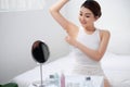 A young girl cares for her body, shaves her armpits with a white razor Royalty Free Stock Photo