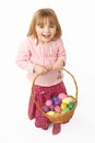 Young Girl Carrying Basket Filled With Easter Eggs