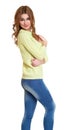 Young girl casual dressed blue jeans and a green sweater posing in studio on white background Royalty Free Stock Photo