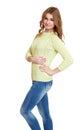 Young girl casual dressed blue jeans and a green sweater posing in studio on white background Royalty Free Stock Photo