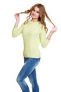 Young girl casual dressed jeans and a green sweater posing in studio on white background Royalty Free Stock Photo