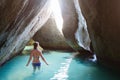 Young girl at cave on tropical beach Royalty Free Stock Photo