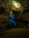 Young girl caver exploring in the cave Royalty Free Stock Photo