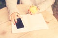 Young girl with cell phone, diary and green apple Royalty Free Stock Photo