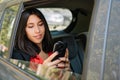 Young girl chatting on her smartphone in car Royalty Free Stock Photo