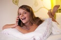 Young girl chatting on the phone with her friend , shallow depth