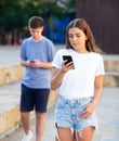 Young girl chatting on smartphone in street Royalty Free Stock Photo