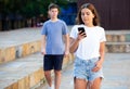 Young girl chatting on smartphone in street Royalty Free Stock Photo