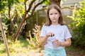 Young girl, child holding a clear transparent modern reusable water bottle outdoors on a sunny day. Hydration, children drinking Royalty Free Stock Photo