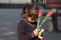 A young girl child selling roses and bubbles in a street of Chandigarh, Selective focus on foreground, giving save girl child mass