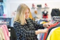 Young girl chooses things in a clothing store