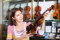 Young girl choosing classical violin Royalty Free Stock Photo