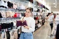 Young girl choosing convenient bra in clothing store Royalty Free Stock Photo